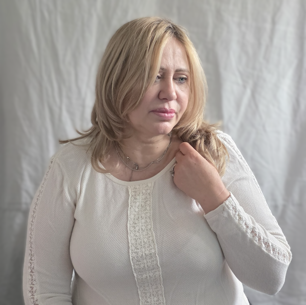 Lora, hairdresser and author of What Your Hair Knows, photographed in soft natural light.